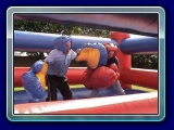 Bouncy Boxing - The Bouncy Boxing is a perfect size and offers hours of Bouncy Boxing Fun! Includes 2 Headgear Helmets and 2 Pair of Giant Boxing Gloves.